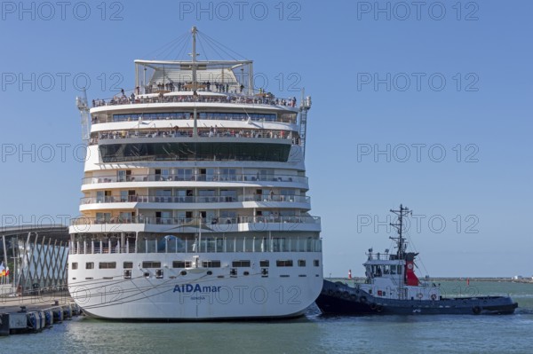 Cruise ship AIDA nova is pressed against quay wall by tugboat, Warnow, Warnemünde, Rostock, Mecklenburg-Western Pomerania, Germany