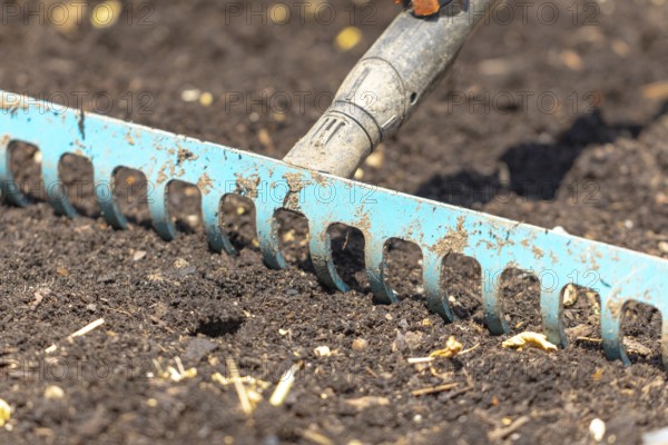 A metal rake works garden soil