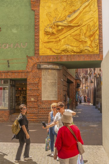 Entrance to Böttcherstrasse, facade relief The Lightbringer by Bernhard Hoetger, inscription, cultural monument in the historic city centre, numerous places of interest, tourist attraction, pedestrian zone, Hanseatic city of Bremen, Germany