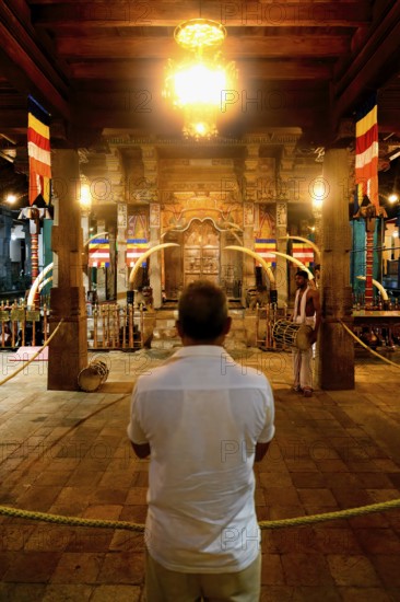 Pilgrims praying in front of the Holy Shrine, Temple of the sacred Tooth Relic or Sri Dalada Maligawa, Kandy, Sri Lanka
