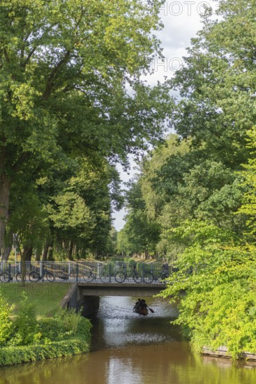 Historic peat canal to the peat harbour at the Bürgerpark from 1866, canoe, bridge, bicycles, attraction, leisure, recreation, groups of trees, nature, city state of Bremen, Germany