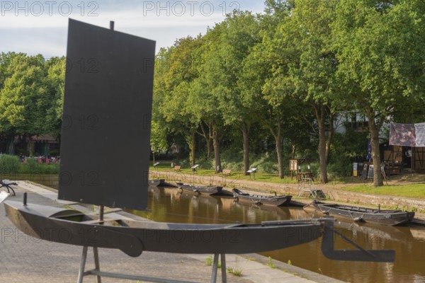 Historic peat harbour with peat barge, mooring, peat as heating material, transport from nearby moors, attraction, tourist boat trip, group of trees, city state of Bremen, Germany