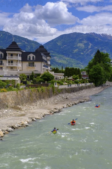 Kayakers in the river in front of the Grandhotel Lienz on the Isel, Lienz, East Tyrol, Austria