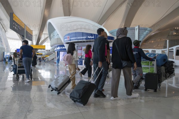 Airport people with luggage, Abu Dhabi, United Arab Emirates