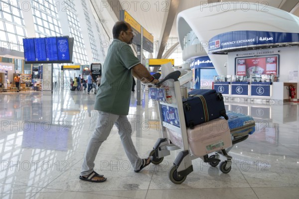 Airport man with luggage, Abu Dhabi, United Arab Emirates