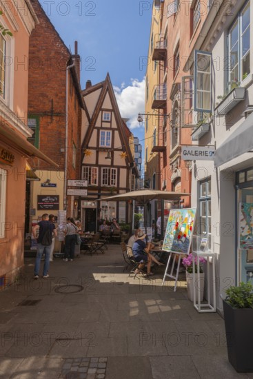 Small square in Wüstestätte alley, renovated Schnoor district with small shops, galleries, restaurants, cafés and residential buildings, Gängeviertel in the old town, former fishermen's and boatmen's settlement, narrow alleys, pedestrian zone, numerous listed buildings, classicist, historicist, baroque and renaissance architecture, tourist attraction, travel destination, pleasure, Hanseatic city of Bremen, Germany