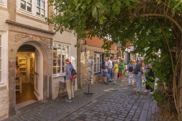 Portal with blessing, city tour, renovated Schnoor district with small shops, galleries, restaurants, cafés and residential buildings, Gängeviertel in the old town, former fishermen's and boatmen's settlement, narrow alleys, pedestrian zone, numerous houses under monument protection, architecture of classicism, historicism, baroque and renaissance, greenery, tourist attraction, destination, pleasure, Hanseatic city of Bremen, Germany