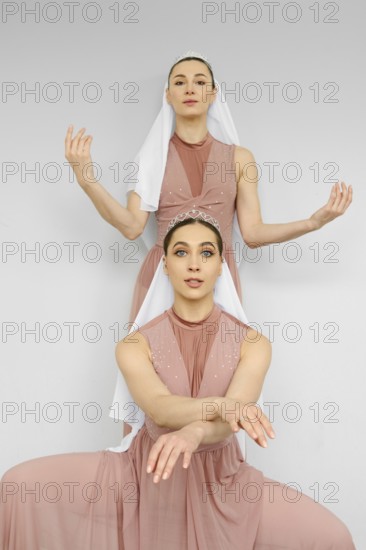 Two female dancers repeat the choreography