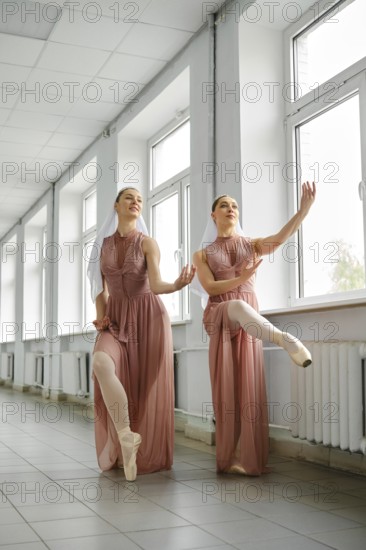 Female ballerinas use a free minute to repeat exercises