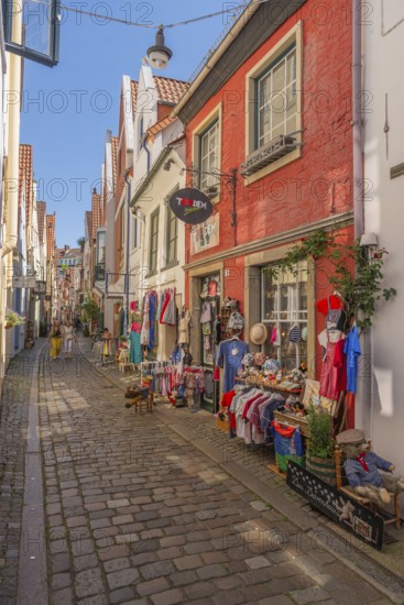 Renovated Schnoor neighbourhood with small shops, galleries, restaurants, cafés and residential buildings, children's shop, people, Gängeviertel in the old town, former fishermen's and boatmen's settlement, narrow alleys, pedestrian zone, numerous houses under monument protection, architecture of classicism, historicism, baroque and renaissance, tourist attraction, destination, pleasure, Hanseatic city of Bremen, Germany