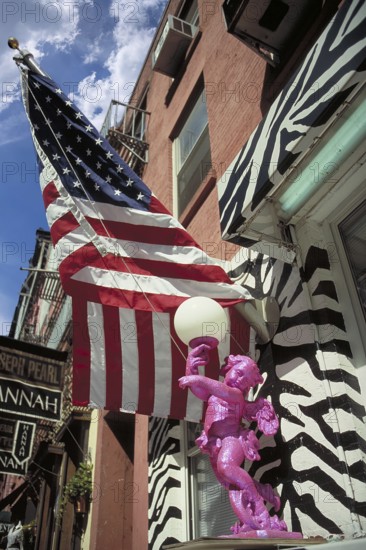 American flag, including an angel as a lamp figure in front of a house entrance, New York City, USA