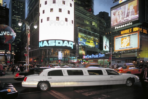 Stretch limousine in Times Square at night, New York City, USA