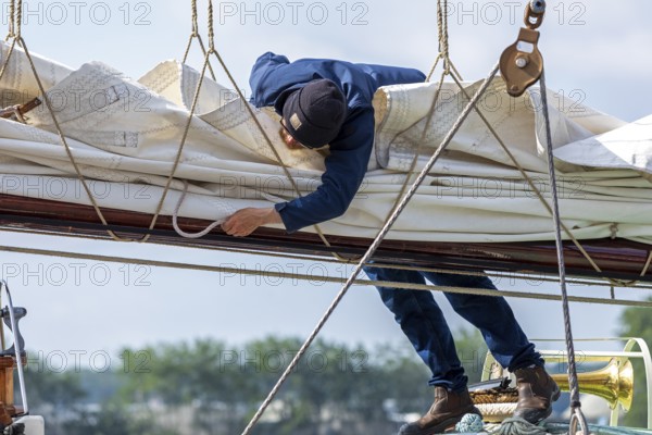 Sailor attaches sail, sailing ship, Kieler Woche, Holtenau, Kiel, Schleswig-Holstein, Germany