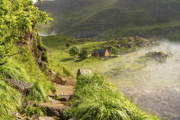 Hiking trail and mountain hut at the Lac des Gloriettes reservoir in the Pyrenees near Gavarnie-GÃ¨dre, France