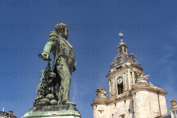 Admiral Duperré statue and the Porte de la Grosse Horloge clock tower in La Rochelle, France