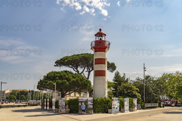 The old red lighthouse Phare Rouge at the harbour in La Rochelle, France