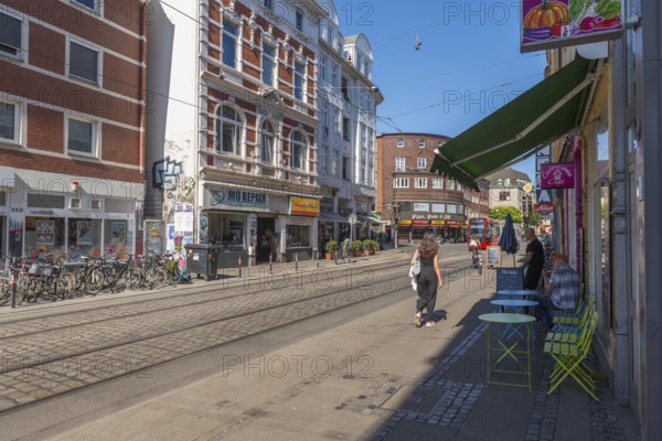 Ostertorsteinweg shopping street in the Ostertor district, tram, bicycles, wide footpath, many shops, cafés, popular residential area, eastern suburb, cobblestones, Wilhelminian style buildings, facades, sunshine, Bremen, Germany