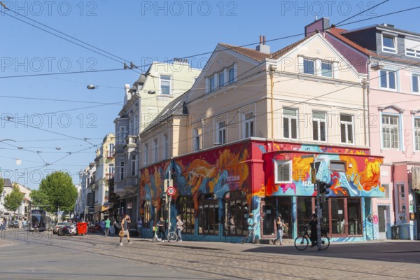 Ostertorsteinweg shopping street in the Ostertor district, car traffic, tram, bicycles, wide footpath, pedestrians, many shops, cafés, popular residential area, eastern suburb, graffiti, cobblestones, Wilhelminian style buildings, facades, Bremen, Germany