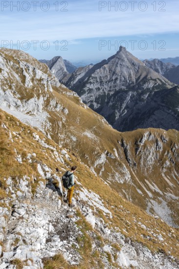 Mountain panorama with picturesque mountain landscape, mountaineers descending from the Gamsjoch, behind mountain peaks Sonnjoch and Schaufelspitze, in autumn, RiÃŸtal in the Eng, Karwendel, Tyrol, Austria