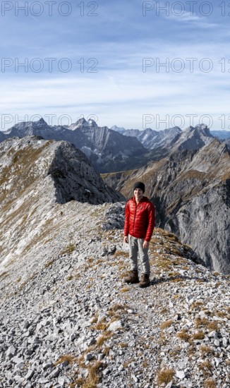 Mountaineer on the ridge of the Gamsjoch, transition to the main summit of the Gamsjoch, behind the ridge of the Hinterautal-Vomper chain, in autumn, RiÃŸtal in the Eng, Karwendel, Tyrol, Austria