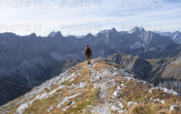 Mountain panorama with picturesque mountain landscape, mountaineers descending from the Gamsjoch, mountain ridge of the Hinterautal-Vomper chain behind, in autumn, RiÃŸtal in the Eng, Karwendel, Tyrol, Austria