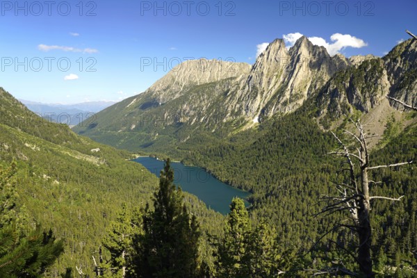 Lake Estany de Sant Maurici and the Els Encantats mountain range in the AigÃ¼estortes i Estany de Sant Maurici National Park seen from above, Catalonia, Spain
