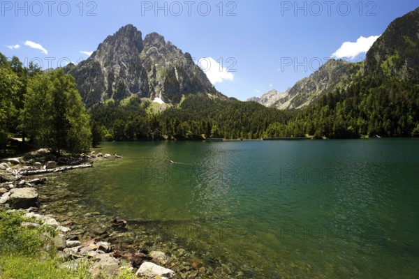 The Estany de Sant Maurici lake and the Els Encantats mountain range in the AigÃ¼estortes i Estany de Sant Maurici National Park, Catalonia, Spain