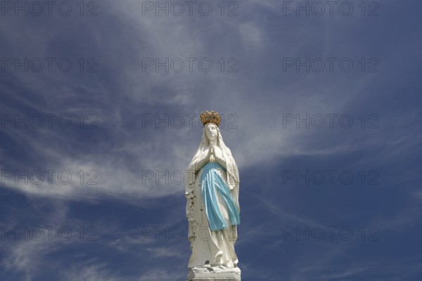 Statue of the Crowned Madonna of Our Lady in Lourdes on Rosary Square in the Marian pilgrimage town of Lourdes, Pyrenees, France