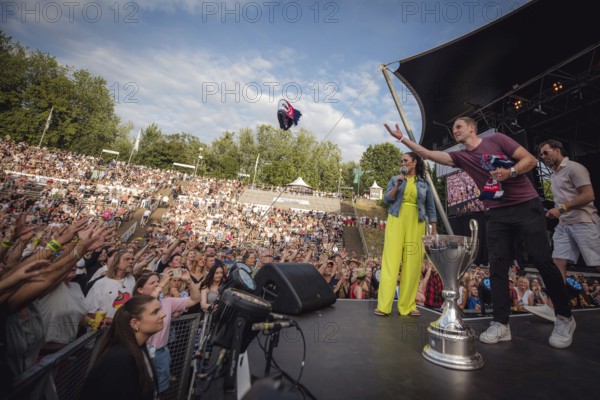 EisbÃ¤ren Berlin players throw scarves and other fan merchandise into the audience at the Berliner Rundfunk 91.4 Open Air at the Berlin ParkbÃ¼hne Wuhlheide on 5 July 2025