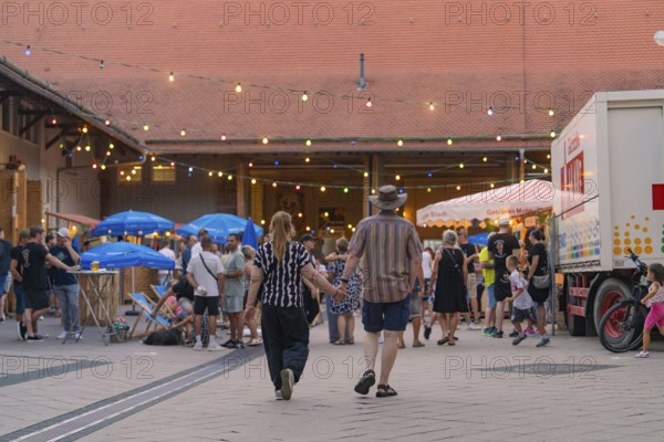Lively scene at an evening event with many people and colourful lights, 950 years Weil der Stadt ceremony, Böblingen district, Germany
