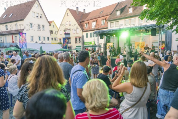 Lively scene of a summer concert with people dancing outdoors, 950th anniversary of Weil der Stadt, Böblingen district, Germany
