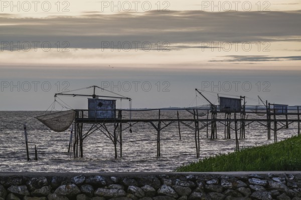 Sunset over Fishing huts over Gironde Estuary, Braud-et-Saint-Louis, France