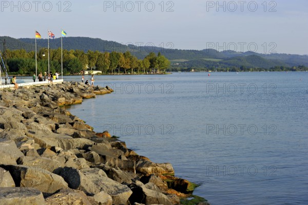 Quay with breakwater made of boulders, Bolsena marina, Porto Turistico di Bolsena, Lake Bolsena, Lago di Bolsena, volcanic crater lake, calm smooth water surface, Bolsena, Province of Viterbo, Lazio, Italy