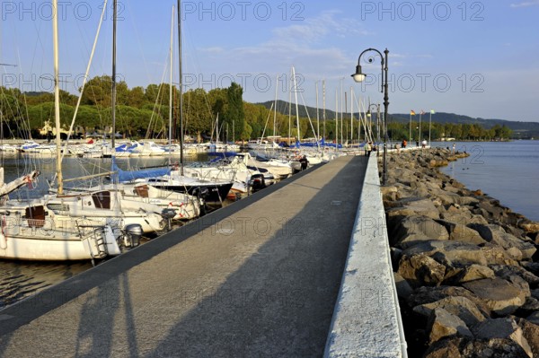 Quay with breakwater made of boulders, Bolsena marina, Porto Turistico di Bolsena, Lake Bolsena, Lago di Bolsena, volcanic crater lake, Bolsena, Province of Viterbo, Lazio, Italy