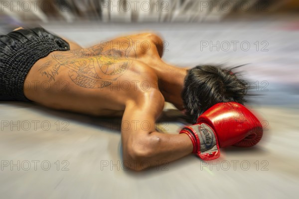 Mop-up picture Muai Thai boxer knocked out on the ground, Pattaya, Thailand