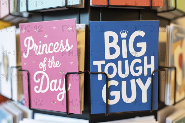 Stereotypical pink and blue birthday greeting cards for children on a rack. Societal expectations taught from a young age through color-coded messages. Generative ai, AI generated