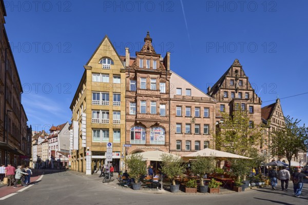 Historic buildings, houses, facade, windows, gable, outdoor area, gastronomy, sunshades, flower pots, trees, general architecture, pedestrians as secondary motif, blue sky, intersection of Theatergasse with KönigstraÃŸe and Hallplatz, Nuremberg, Middle Franconia, independent city, Bavaria, Germany