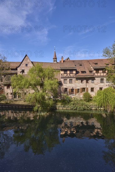 River Pegnitz, historic buildings, Babylon willow (Salix babylonica), trees, reflections, water surface, blue sky, cirrostratus clouds, Vordere Insel SchÃ¼tt, Nuremberg, Middle Franconia, independent city, Bavaria, Germany