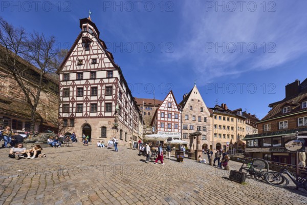 Pilatus House, town house, late Gothic architectural style, historic buildings, half-timbered houses, square, cobblestone pavement, outdoor area of a restaurant, people as accessories, pedestrians, blue sky, cirrostratus clouds, Beim TiergÃ¤rtnertor, Obere Schmiedgasse, TiergÃ¤rtnertorplatz, Nuremberg, Middle Franconia, independent city, Bavaria, Germany