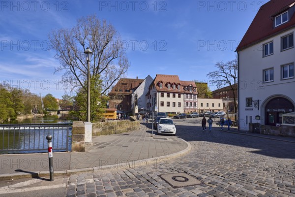 General architecture, street, cobblestone pavement, parking lane with vehicles, metal railing, bollard, lantern, trees, river Pegnitz, blue sky, cirrostratus clouds, intersections between HeubrÃ¼cke, Unterer Bergauerplatz, Peter-Vischer-StraÃŸe and Wespennest, Nuremberg, Middle Franconia, independent city, Bavaria, Germany