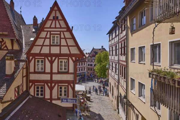 Historic half-timbered houses, residential buildings, gables, pointed roofs, faÃ§ade, window, balcony, backlight, blue sky, cirrostratus clouds, Am Ã–lberg, Beim TiergÃ¤rtnertor, Obere Schmiedgasse, Nuremberg, Middle Franconia, independent city, Bavaria, Germany