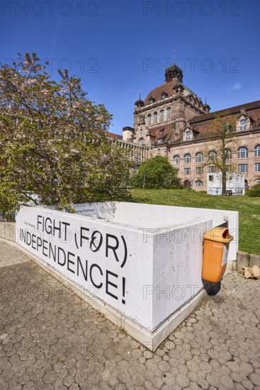 Nuremberg State Theatre, architect Christian Heinrich Seeling, theatre, opera, blossoming tree, Japanese flowering cherry (Prunus serrulata), wall, fight for independence, public rubbish bin, blue sky, cloudless, Richard-Wagner-Platz, Nuremberg, Middle Franconia, independent city, Bavaria, Germany