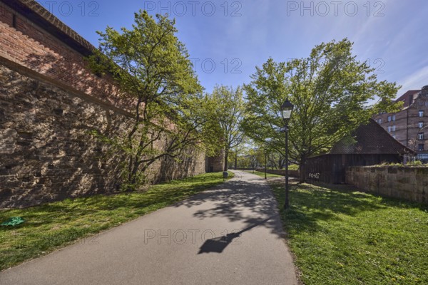 Old town, city fortification, city wall, footpath, trees, lawn, lantern, backlight, shadow, blue sky, cirrostratus clouds, Frauentor wall, Spittlertorzwinger, Nuremberg, Middle Franconia, independent city, Bavaria, Germany