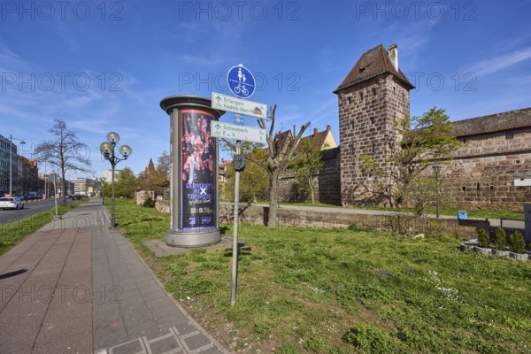 Footpath and cycle path, traffic sign shared footpath and cycle path, advertising pillar, lantern, trees, meadow, city fortification, city wall, defence defence tower, blue sky, cirrostratus clouds, Frauentor wall, Frauentor moat, Nuremberg, Middle Franconia, independent city, Bavaria, Germany
