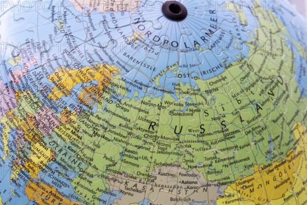 Puzzle globe. Map made from puzzle pieces. Russia and North Pole
