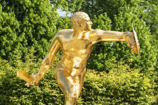 Golden sculpture, warrior with shield and sword, Herrenhausen Gardens, Baroque garden at castle Herrenhausen, HerrenhÃ¤user GÃ¤rten, Hanover, Germany
