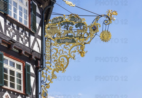Town view of Nagold in the northern Black Forest. Half-timbered house Hotel Post on the suburban square with artistic nose sign. Nagold, Baden-WÃ¼rttemberg, Germany