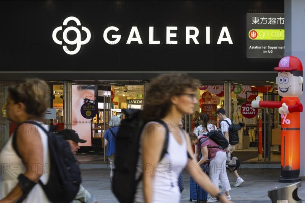 Galeria Kaufhof. Logo and entrance of the department stores' with people in Stuttgart, Baden-WÃ¼rttemberg, Germany
