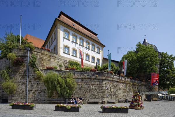 Marienplatz cobbled, flower pots, town wall, above catholic parish office St. Johannes, on the right rose tower, upper town, old town, Kronach, Upper Franconia, Franconia, Bavaria, Germany