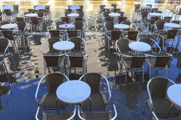 Piazzetta, chairs and tables of a restaurant in Acqua alta, Venice, Veneto, Italy